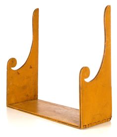 an old wooden shelf with two curved sections