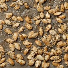 some kind of food that is on top of a table and has seeds all over it