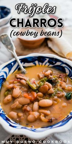 a bowl filled with beans and broccoli on top of a table