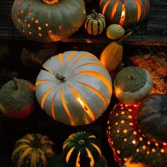 pumpkins and gourds lit up with candles