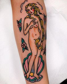 a woman's naked body with flowers and leaves around her legs is shown on the arm