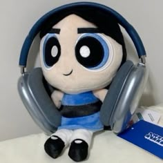 a stuffed animal with headphones sitting on top of a table