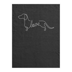 a black towel with the word love written in white ink on it and a dachshund silhouette