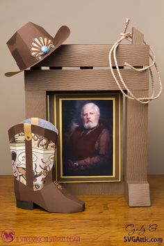 a cowboy's hat and boots are sitting next to a photo frame on a table