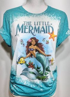 the little mermaid t - shirt is on display