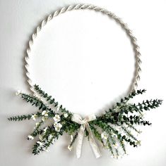 a necklace with white flowers and green leaves