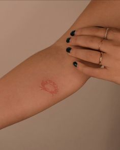 a woman's arm with a small tattoo on the left side of her arm