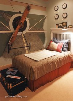 a bed room with a neatly made bed and clocks on the wall