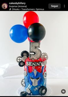 a birthday cake made to look like a transformer engine with balloons on top that say 5