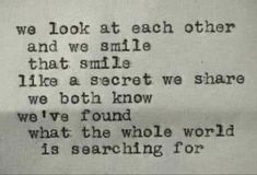 an old typewriter with the words we look at each other and we smile that smile like a secret we know we've found what the whole world is searching for