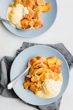 two plates with ice cream and peach cobbler on them