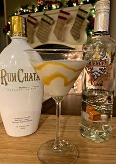 a bottle of rumchata next to a martini glass