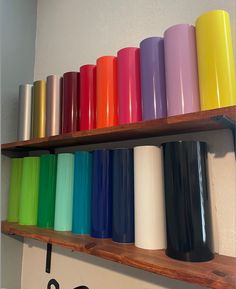 the shelves are filled with many different colored cups