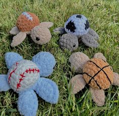 four stuffed animals laying in the grass together