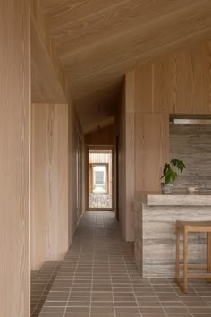 a long hallway with wooden walls and tile flooring