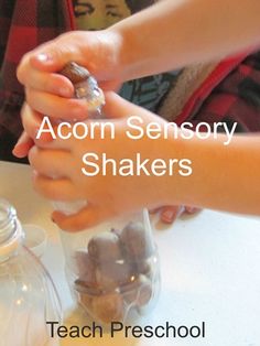 two children are playing with an acorn sensory shakers