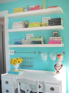 a white desk and shelves in a room