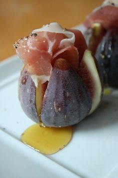 figs with prosciutto and cheese on a white plate