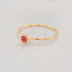 Celebrate your July birthday with the Large July Birthstone Ring, featuring a vibrant 4mm bold red CZ stone. This striking stone represents love and courage, making it a powerful addition to any jewelry collection. The ring is crafted with a 14K yellow gold-filled band, offering both elegance and durability. Whether worn alone or stacked with other personalized rings, this piece is a perfect way to showcase your unique style. Features 4mm CZ stone with a vibrant bold red hue. 14K gold-filled ban Gold Stackable Ruby Birthstone Ring, Red Birthstone Ring With Round Stone For Gift, Red Birthstone Stackable Rings, Adjustable Red Birthstone Ring, Red Birthstone Ring With Round Band, Gold Ruby Crystal Ring With Birthstone, Red Stackable Rings With Bezel Setting As Gift, Red 14k Gold Stackable Rings As Gift, Red Stackable Birthstone Ring As Gift