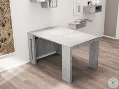 a white table sitting on top of a hard wood floor next to a wall mounted clock