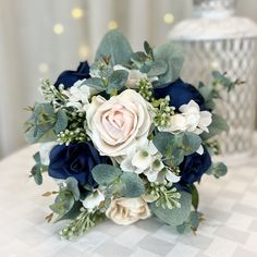 a bouquet of white and blue flowers on a table