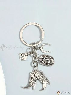 a silver key chain with charms on it