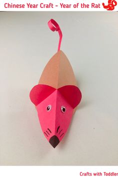 an origami mouse with a pink hat on it's head is featured in the article chinese year craft - year of the rat