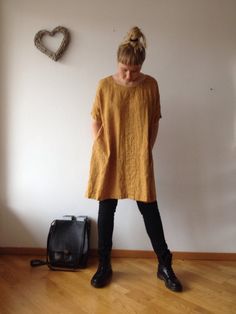 "Lovely oversized linen tunic with pockets and half length sleeves for everyday wear. This loose tunic is perfect with trousers and leggings or to wear as a dress. Great texture and lovely wrinkles. Made from high quality orange melange linen of medium-light weight. You can choose other colour and weight linens from our selection (see the last image). Each piece is individually cut, sawn and pre-washed. We really love making dresses for various sizes - from petit to plus size and more. For the b Linen Tunic Outfit, Tunic Tops Outfit, Linen Tunics For Women, Tunic Outfit, Tunics For Women, Tunic Sewing Patterns, Plus Size Tunic, How To Wear Leggings, Linen Tunic Dress