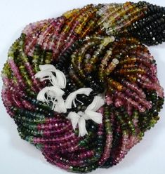 multicolored seed beads with white flowers on them