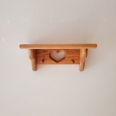 a wooden shelf with a heart cut out of it