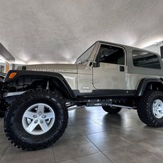 a jeep is parked in a large garage