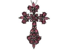 .42ctw round, .90ctw marquise and 2.40ctw pear shape raspberry color rhodolite garnet rhodium over sterling silver cross pendant with 18" Singapore chain. Measures approximately .31"L x .88"W. 2.5mm bail. Lobster claw clasp with a 2" extender. Finished back. Black rhodium. Silver Marquise Jewelry With Gemstone Accents, Silver Jewelry With Marquise Gemstone Accents, Silver Jewelry With Gemstone Accents In Marquise Shape, Silver Multi-stone Pear-shaped Jewelry, Silver Pear-shaped Multi-stone Jewelry, Pear-shaped Multi-stone Silver Jewelry, Silver Pear-shaped Gemstone Jewelry, Raspberry Color, Sterling Silver Cross Pendant