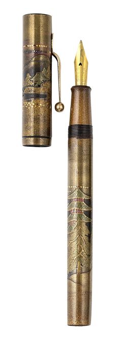 a gold colored pen with an intricate design on the top and bottom, sitting in front of a white background