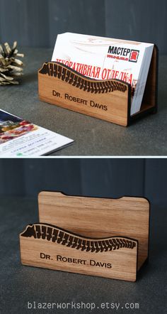 a wooden business card holder with the word dr robert davis printed on it and an envelope inside