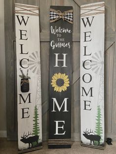 three wooden signs with the words welcome to goisier, home and deer on them