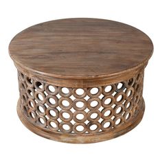 a round wooden table sitting on top of a white floor covered in wood circles and holes