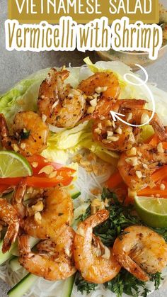 a plate with shrimp, lettuce and carrots on it