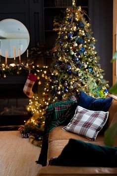 a living room with a christmas tree in the corner