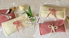 crochet pencil case with flowers and pens on the side, next to it