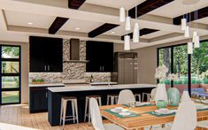 a large open concept kitchen and dining room with wood flooring, white chairs and black cabinets