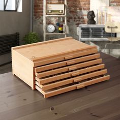 a stack of wooden drawers sitting on top of a table