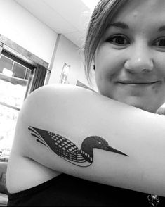 a woman with a bird tattoo on her arm