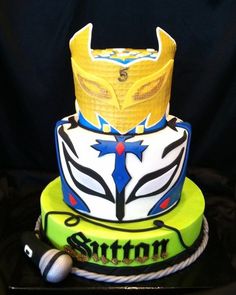 a birthday cake decorated with an image of a helmet on the front and bottom tier