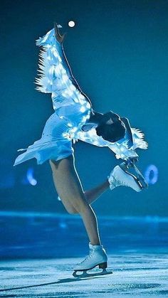 a woman is performing on ice skates