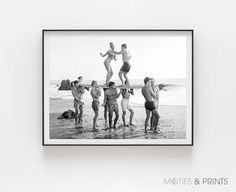 a group of people standing on top of a surfboard