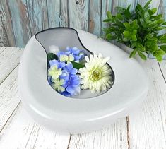 a white bowl with blue and white flowers in it