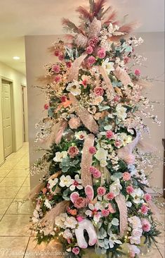 a decorated christmas tree with pink and white flowers