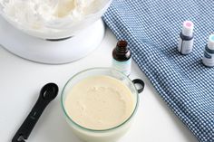 a bowl with whipped cream in it next to an electric toothbrush and other items