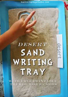 a sand writing tray with the words desert written on it and a hand making a heart