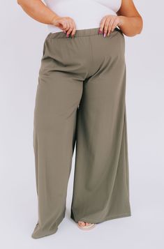 Our PLUS SIZE - Beyond Compare Pants are the perfect addition to your closet! Made with a smokey sage color and wide-legged style, these pants are sure to add a stylish touch to any look. Plus, they boast an elastic waistband for comfort and convenient pockets for convenience. So go ahead—it's impossible to go wrong with these pants! Details Wide leg Elastic waistband Pockets! Soft Sizing Approximate measurements: SIZE LENGTH WAIST INSEAM 1XL 43” 32” 31” 2XL 43” 34” 31” 3XL 44” 36” 31” Fabric has stretch Model is 5’8” wearing 3XL Material 92% Nylon 8% SpandexHand wash cold No bleachHang dryOr dry clean Spring Khaki Wide Leg Full-length Pants, Olive Wide Leg Pants For Spring, Olive High-waisted Pants For Spring, Olive Wide Leg Pants With Elastic Waistband, Olive Wide Leg Relaxed Fit Pants, Fall Wide Leg Khaki Pants With Elastic Waistband, Khaki Wide Leg Pants With Elastic Waistband For Fall, Green Wide Leg Harem Pants, Olive Wide Leg Bottoms For Summer